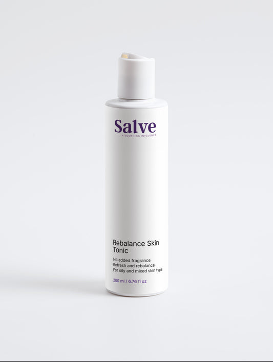 A white bottle with a pump dispenser labeled 'Salve' containing a skin tonic.